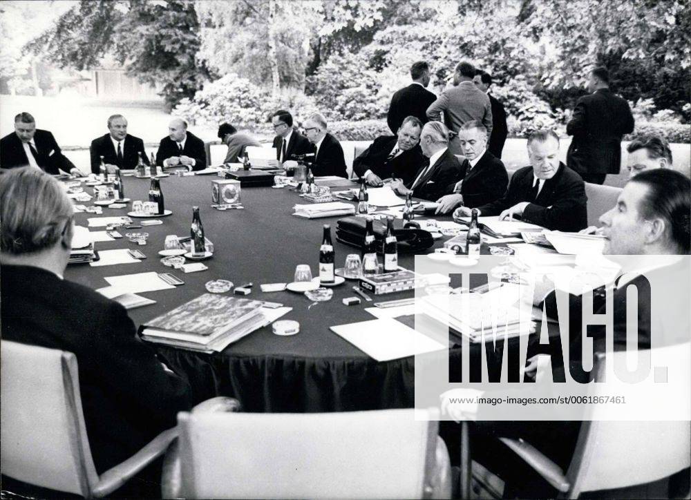 Jul. 07, 1967 - The chancellor and his ministers decided to have some fresh air. Surely this will help them make decisions quickly and correctly. They are discussing the finance planning together. Picture was taken on July 6, 1967 in Schaumburg Palace s park. - ZUMAk09