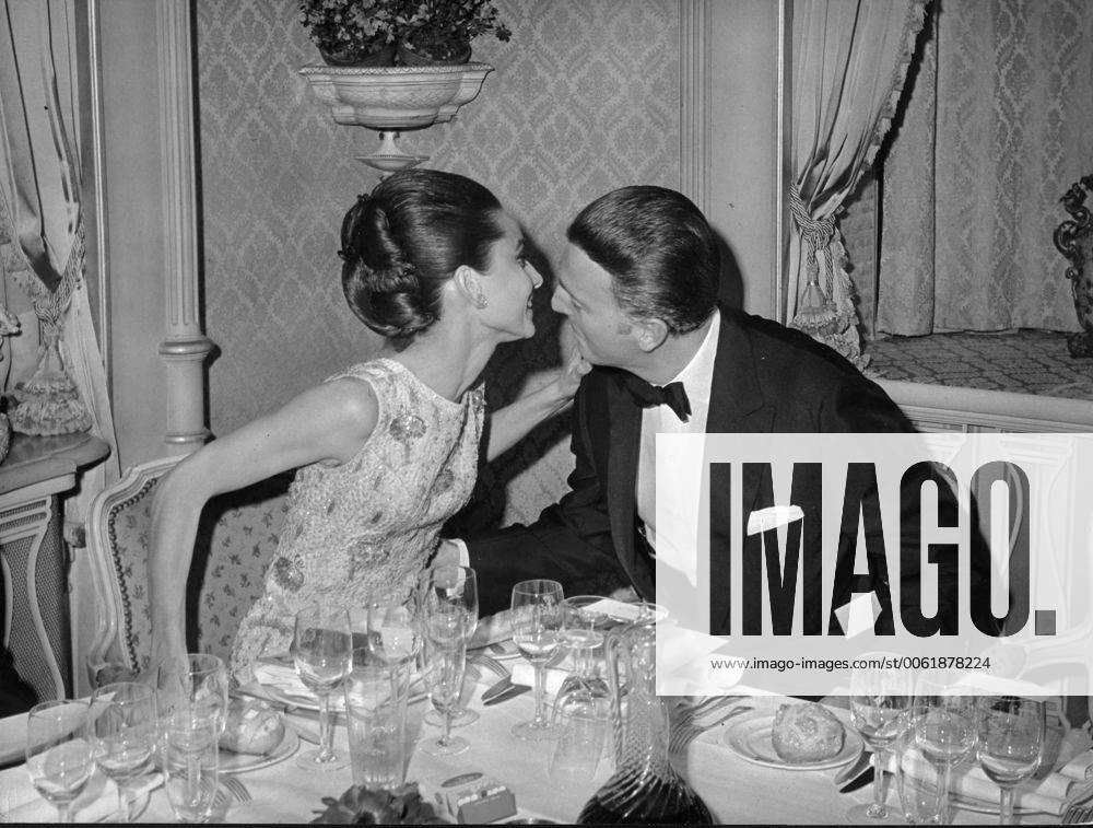 Dec. 22, 1964 - Paris, France - Actress AUDREY HEPBURN whispers to fashion designer HUBERT de GIVENCHY during a reception prior to the premiere of Hepburn s latest film, My Fair Lady. Paris France - ZUMAk09