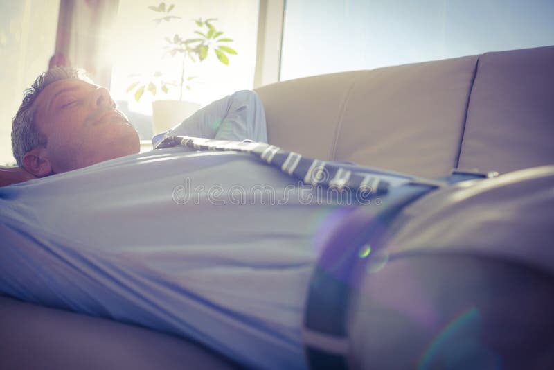 Businessman relaxing on a couch, Businessman relaxing on a couch in living room model released