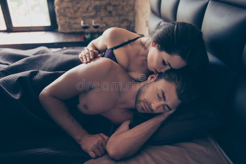 It is just a dream, just my erotic fantasy! Close up photo of pa, It is just a dream, just my erotic fantasy! Close up photo of passionate attractive charming brunette tempting women whispering pleasant words to her sleepy man, they are lying in bed under a blanket