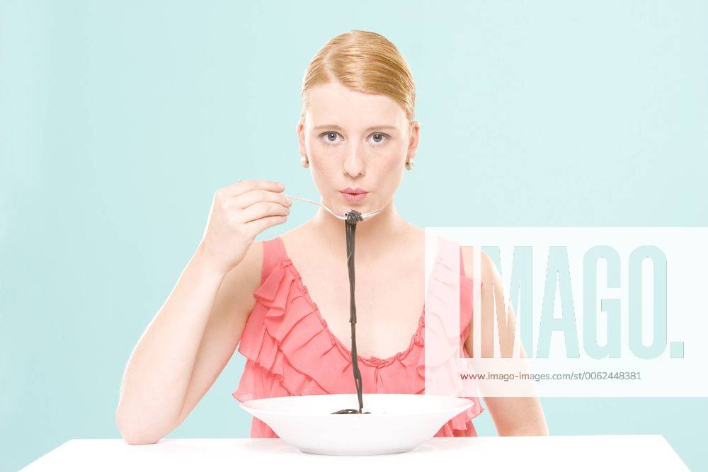 Woman eating noodles, portrait model released CLF00453