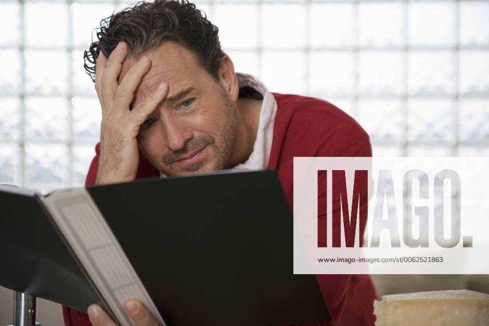 Man holding school report, hand on head model released property released WESTF03319