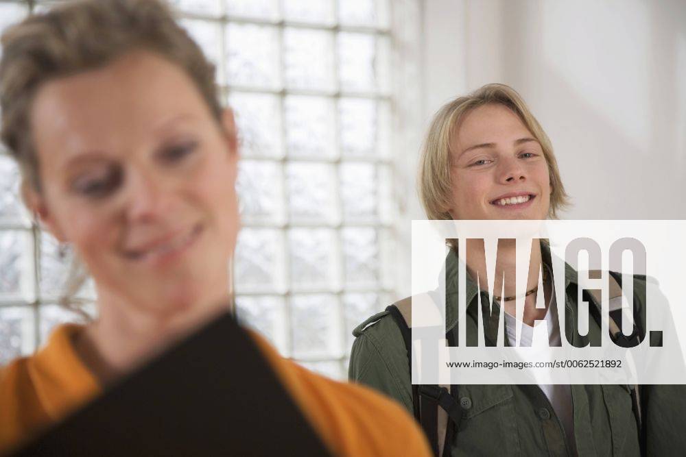 Mother and teenage son (16-17) smiling (focus on background) model released property released WESTF03375