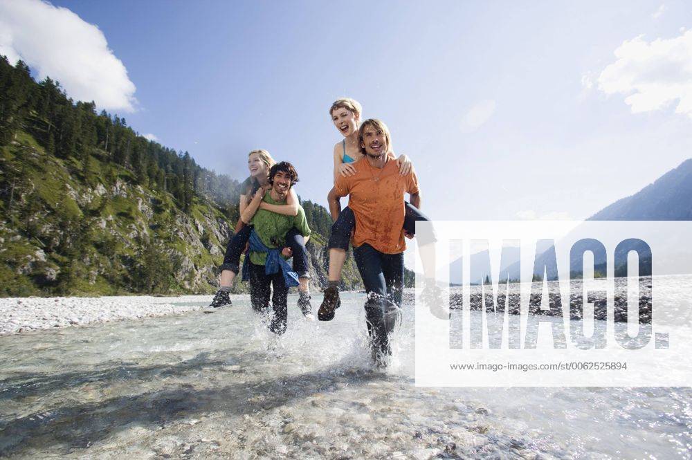 Germany, Bavaria, Tölzer Land, Men carrying young women piggyback model released WESTF09918