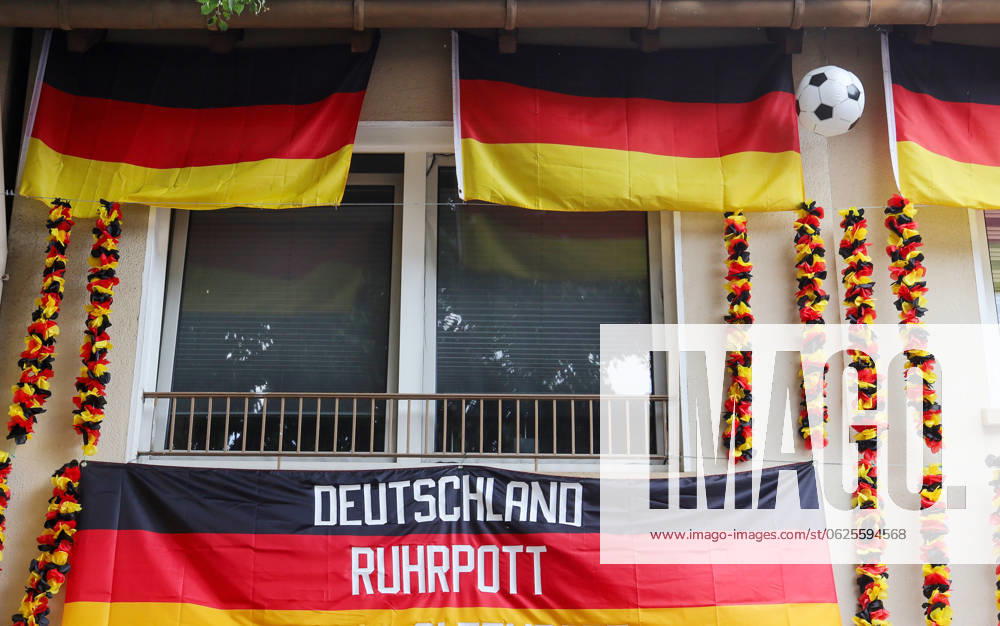 Germany, NRW, European Football Championship, UEFA Euro 2024, Germany flags, a Ruhrpott flag and fabric flowers surround a window, fans, fan, flags, flowers, Ruhr area, Germany