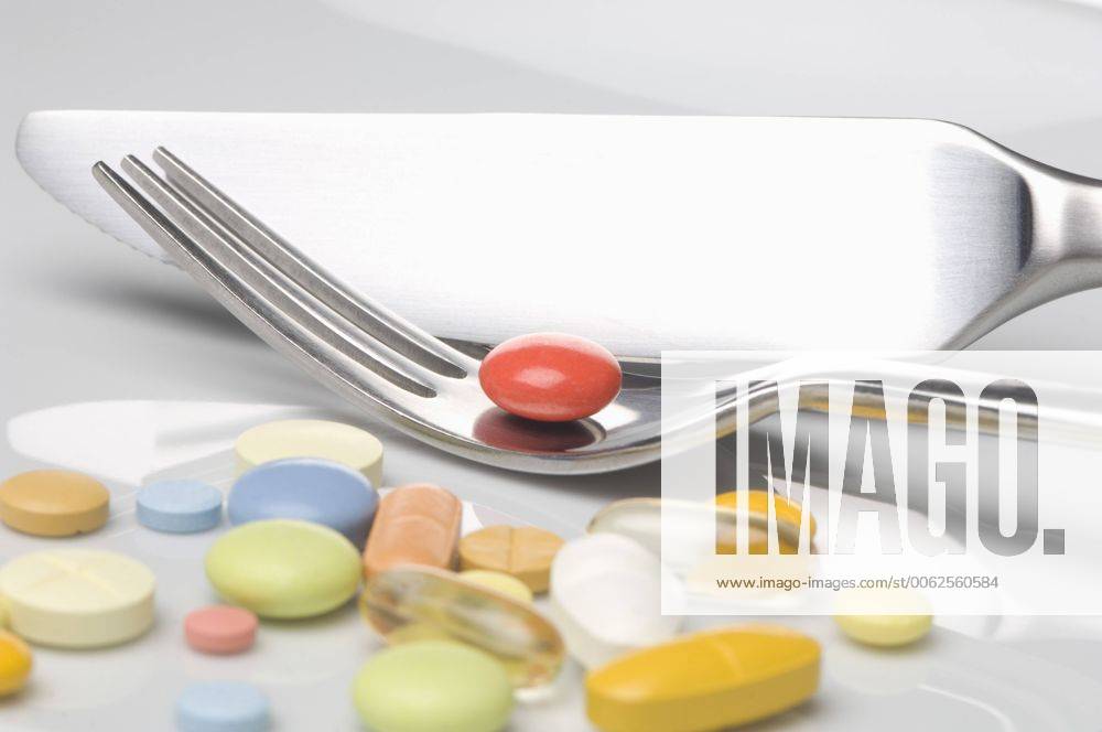 Variety of medicines with fork and knife, close up CRF002179