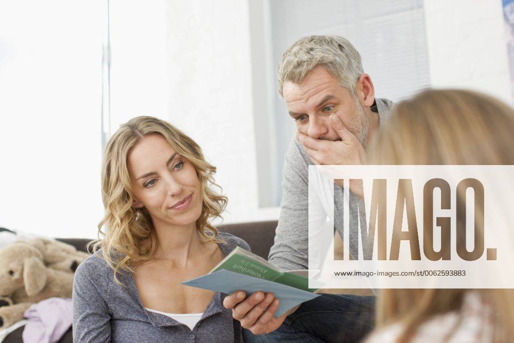 Germany, Leipzig, Parents watching school report of girl model released property released WESTF018365