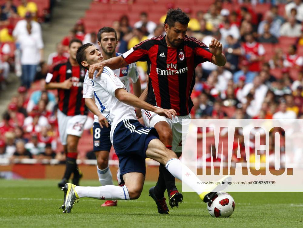Football - Emirates Cup - AC Milan v Olympique Lyonnais Maxime Gonalons of Lyon (L) tackles Marco Borriello of AC Milan at Emirates Stadium