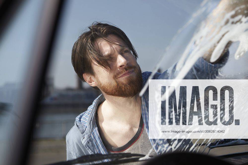 Man washing front window of a car model released FMKF001210