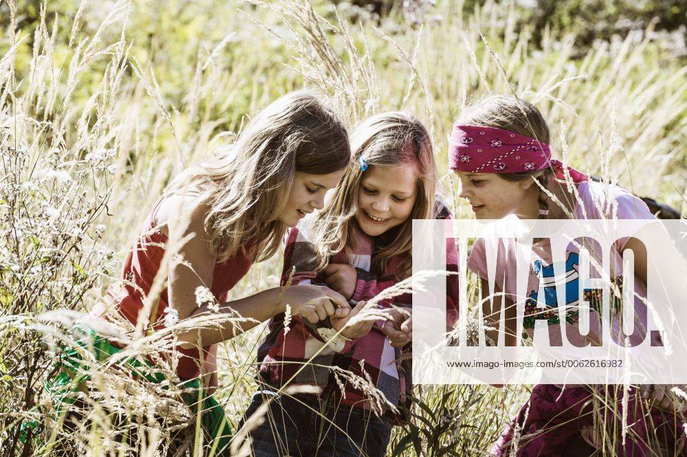Three girls exploring the nature model released HHF004817