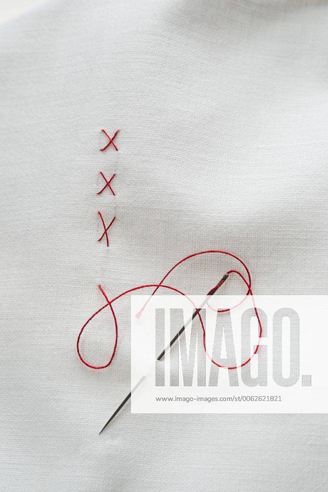 Embroidery cross on fabric with red thread CRF002389