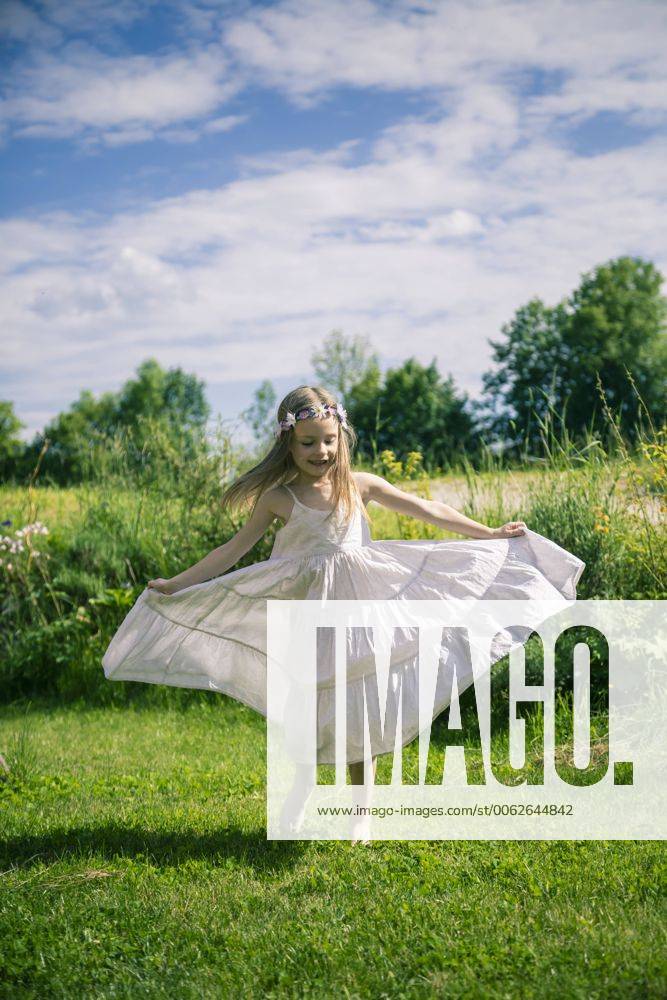 Girl in white summer dress on meadow model released SARF000680