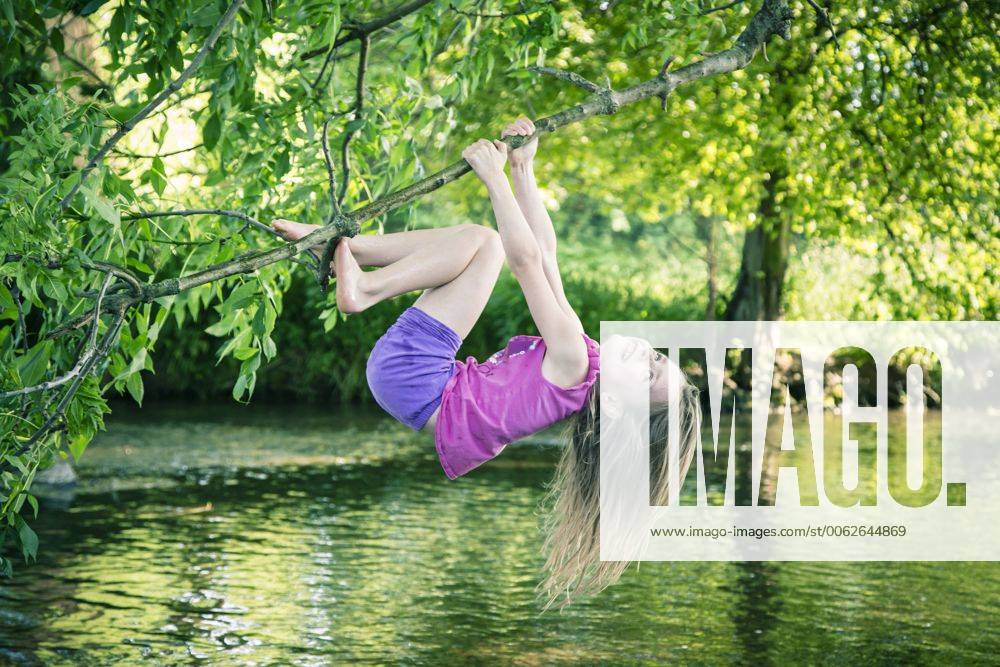 Little girl climbing on branch model released SARF000699