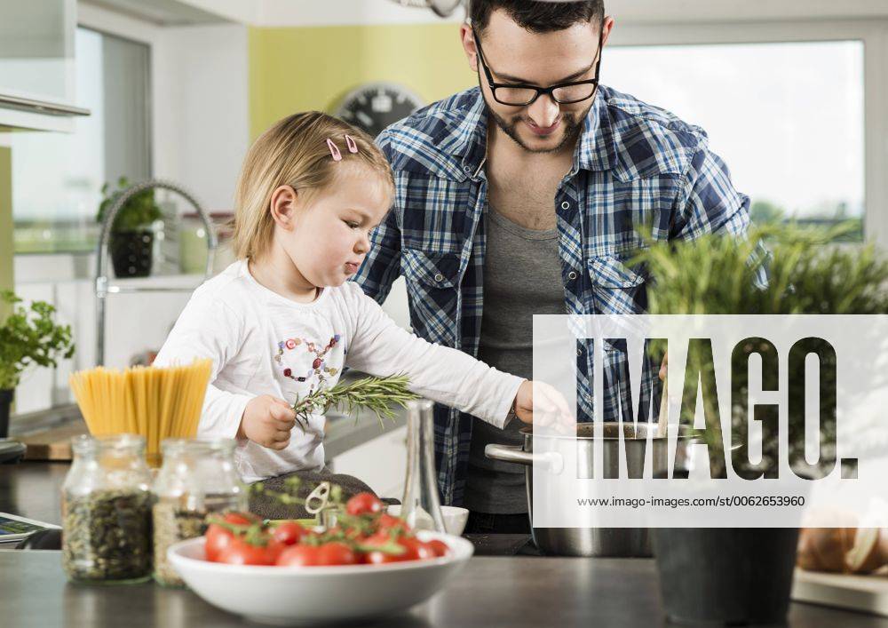 Father and daughter cooking in kitchen model released property released UUF000479