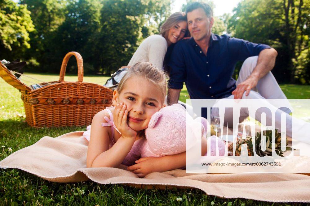 Portrait of little girl with her parents sitting in the background model released Symbolfoto CHAF000140