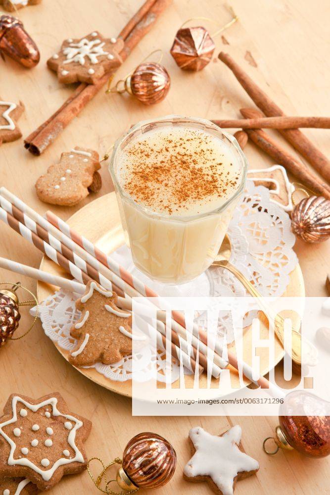 Ein Glas Eierpunsch mit Zimt und Weihnachtsdekoration 1079701655
