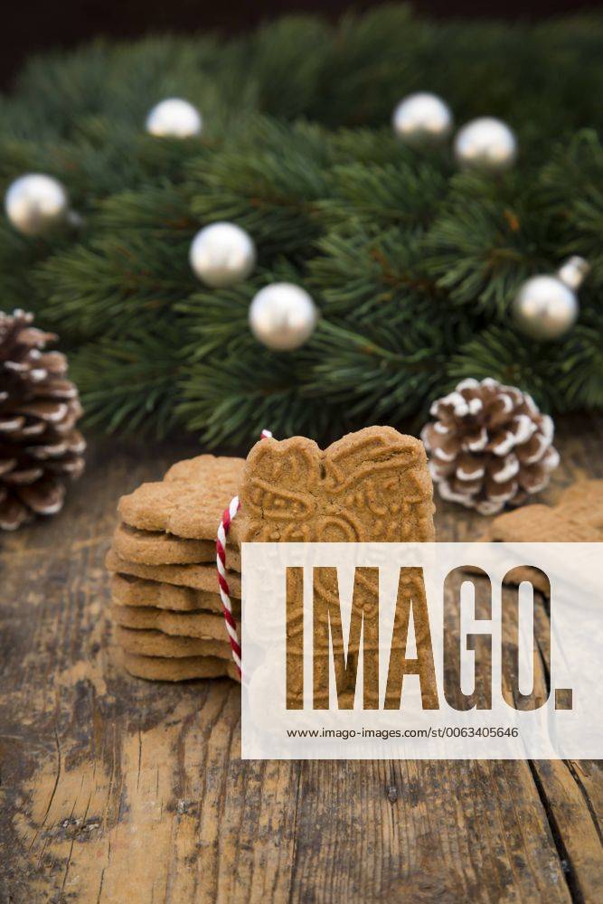 Almond biscuits, fir cones and decorated fir branch on wood LVF002442