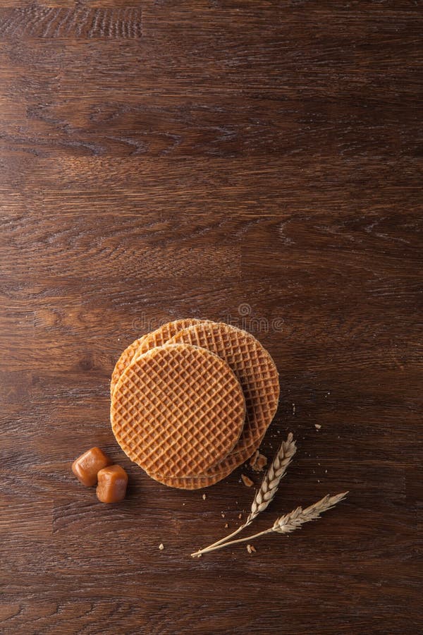 Waffles with caramel on wood, Waffles with caramel on wooden background. Top view