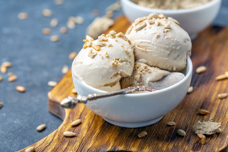 Ice cream with halva and sunflower seeds close up, Homemade sundae with sunflower oil and halva in a white ceramic bowl close-up, selective focus