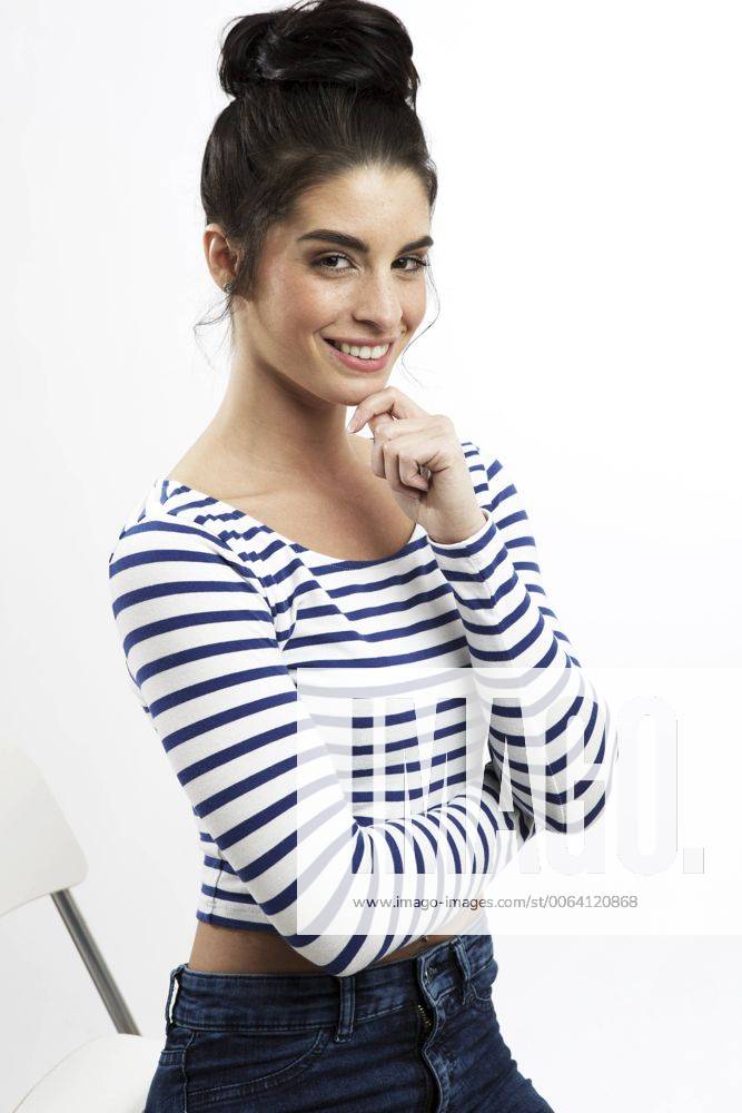 Portrait of smiling young woman with bun model released Symbolfoto GDF000692