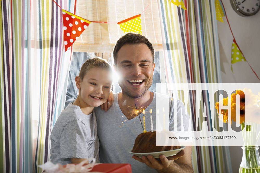 Father and son with birthday cake model released Symbolfoto property released PDF000746