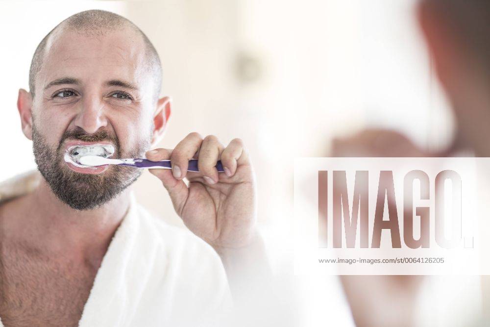 Mirror image of man brushing his teeth model released Symbolfoto property released ZEF003145