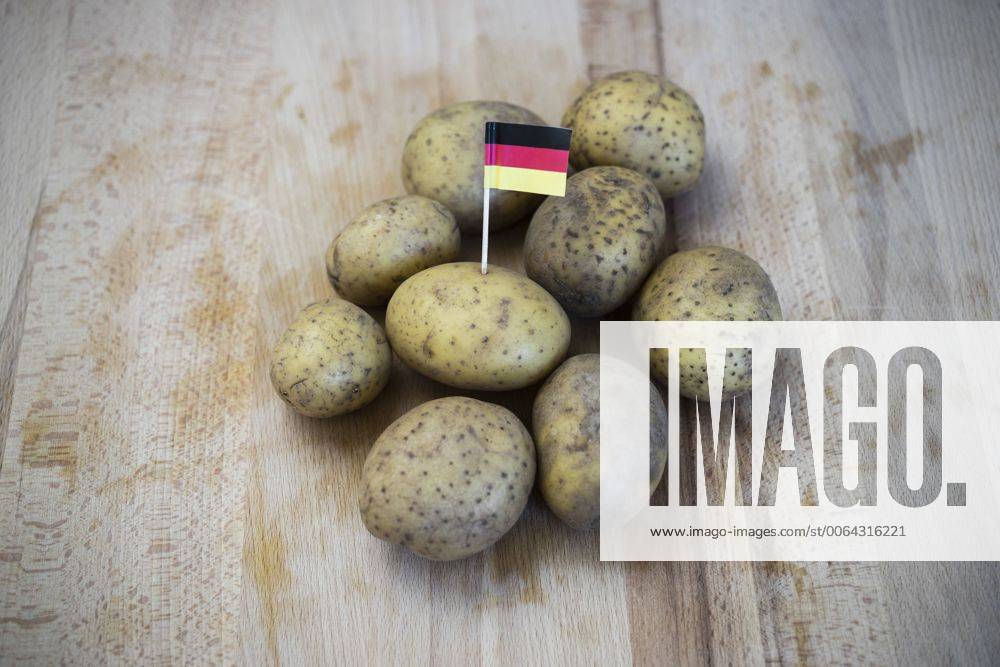 Row potatoes and small german little flag on wood CHPF000121