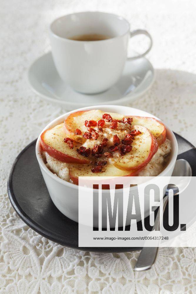 Bowl of porridge with roasted apple and cup of coffee EVGF001399