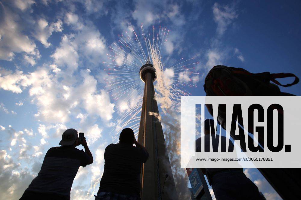 Toronto, Ontario, Canada - Toronto, Canada - July 10 - People watch fireworks shoot out of the CN Tower at the start of the Opening Ceremonies of the Pan Am games, outside of the Rogers Centre in Toronto July 10, 2015.. Toronto Canada - ZUMAt14_