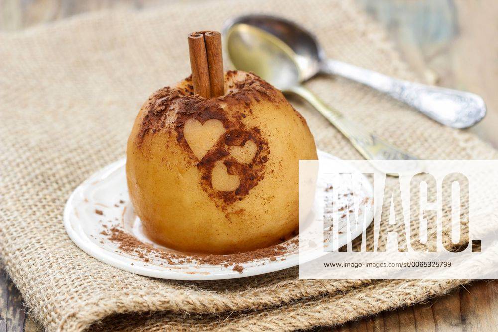 Baked apple decorated with cinnamon heart shape ornament