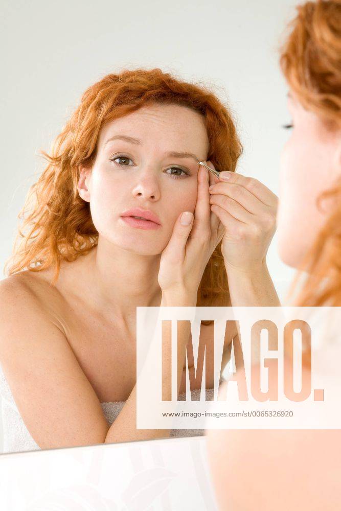 Woman correcting eyebrows.
