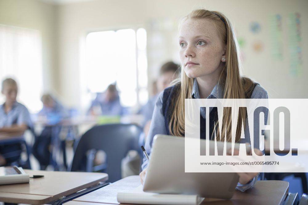 Schoolgirl in classroom with digital tablet model released Symbolfoto property released ZEF004962