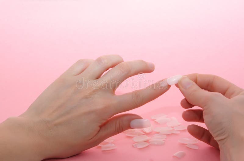 False nails, Woman hands taking care of false nails