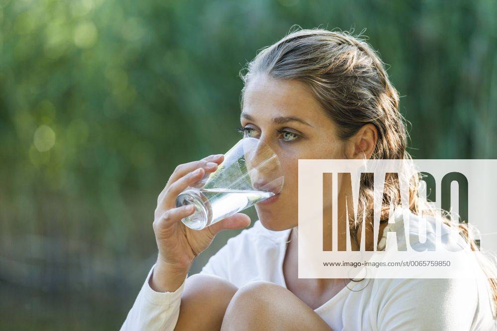 Beautiful woman with wet hair drinking glass of water model released Symbolfoto property released TCF004821