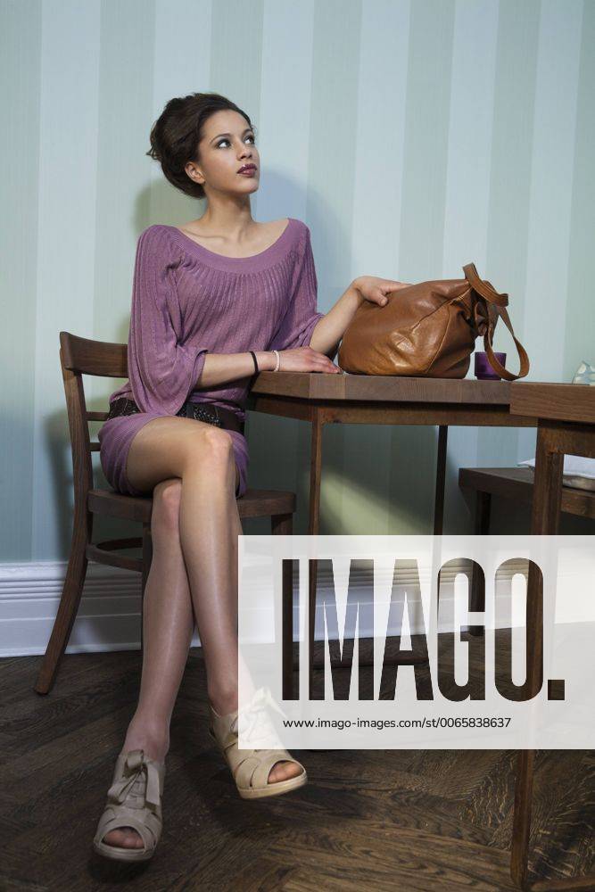 Young woman sitting in a cafe model released Symbolfoto TAM000220