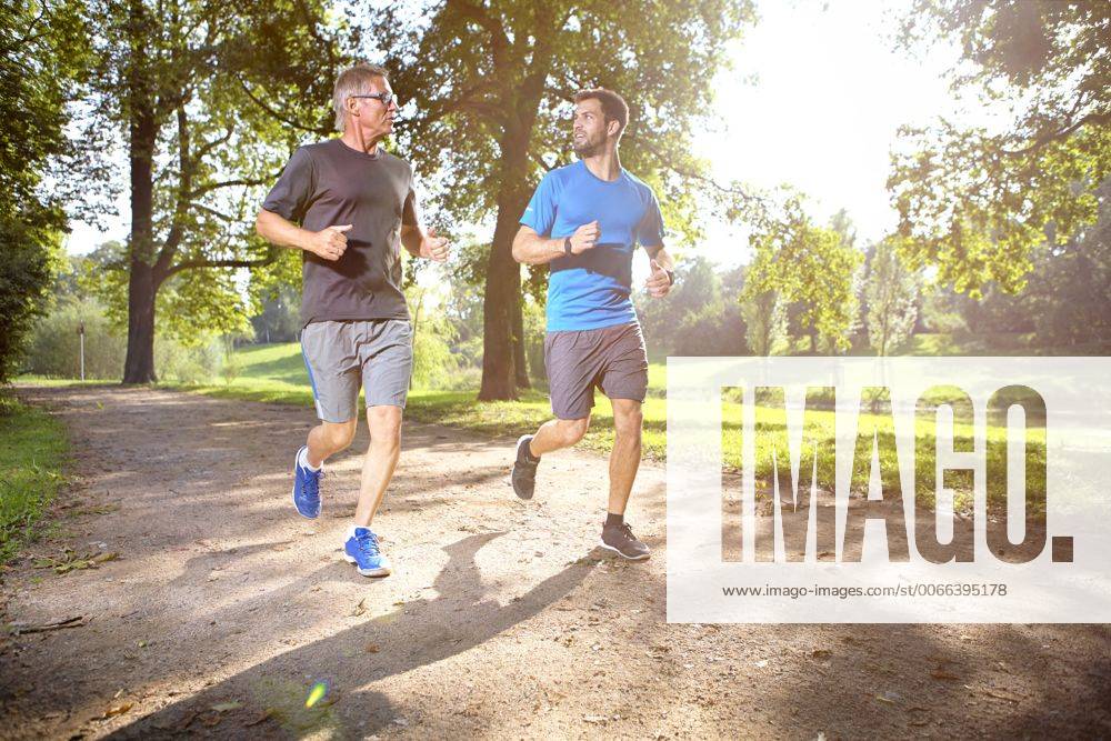 Two men jogging together in a park model released Symbolfoto SEGF000409