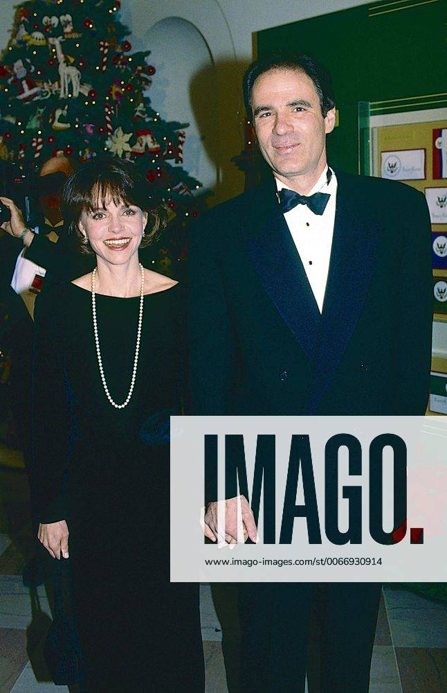 Washington, District of Columbia, United States of America - Washington, DC. Dec 1993.Sally Field and her husband Alan Greisman arrive at the White House reception for the Kennedy Center Honors. .Sally Margaret Field is an American actress and director. She is known for her film roles in Smokey and the Bandit (1977), Norma Rae (1979), Places in the Heart (1984), Murphy s Romance (1985), Steel Magnolias (1989), Mrs. Doubtfire (1993), Forrest Gump (1994), and Lincoln (2012)..Field began her career in the 1960s sitcoms Gidget (1965Ã?66) and The Flying Nun (1967Ã?70). She has won and been nominated for numerous awards, including winning an Academy Award for Best Actress, a Golden Globe Award and the Best Actress prize at the Cannes Film Festival for playing Norma Rae Webster in Norma Rae (1979), as well as the Best Actress Academy Award and a Golden Globe Award for playing - ZUMAr142
