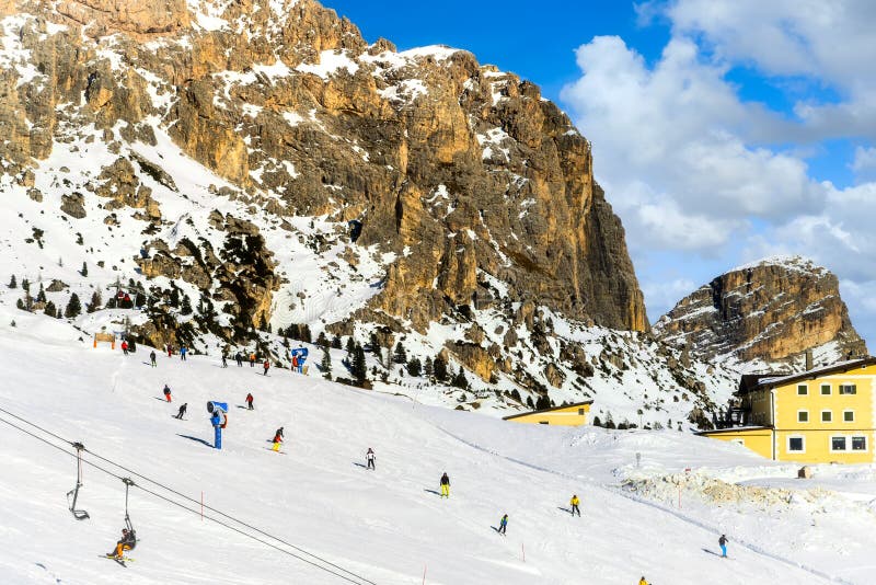 Wolkenstein in Groeden in winter with chairlift and skiers, Dolomite, Italy, Wolkenstein in GrÃÂ¶den in winter with chairlift and skiers, Dolomite, Italy