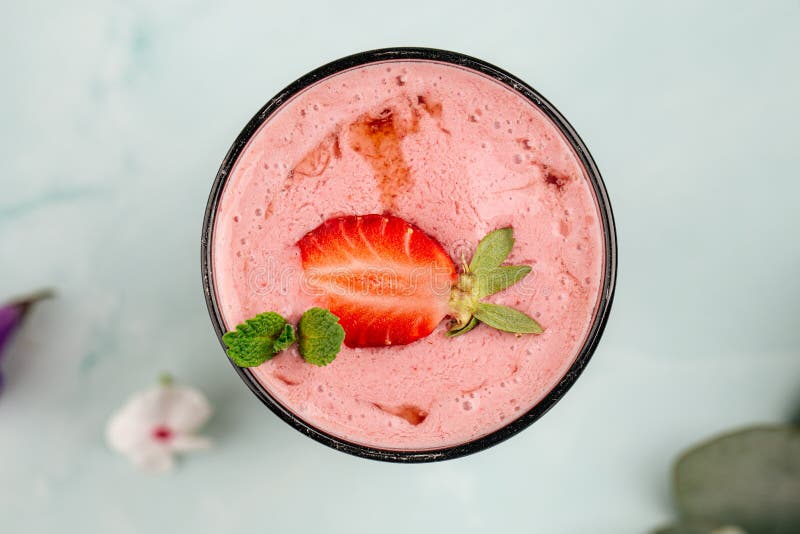 Glass of strawberry smoothie cocktail, Glass of strawberry smoothie cocktail on the blue background