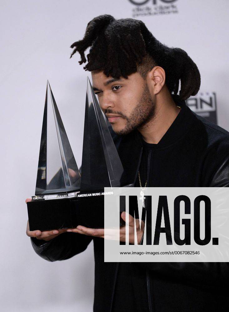 Recording artist The Weeknd, winner of Favorite Soul R&B Male Artist and Favorite Soul R&B Album, appears backstage during the 43rd annual American Music Awards held at Microsoft Theater in Los Angeles on November 22, 2015. LAP20151122427 JIMxRUYMEN