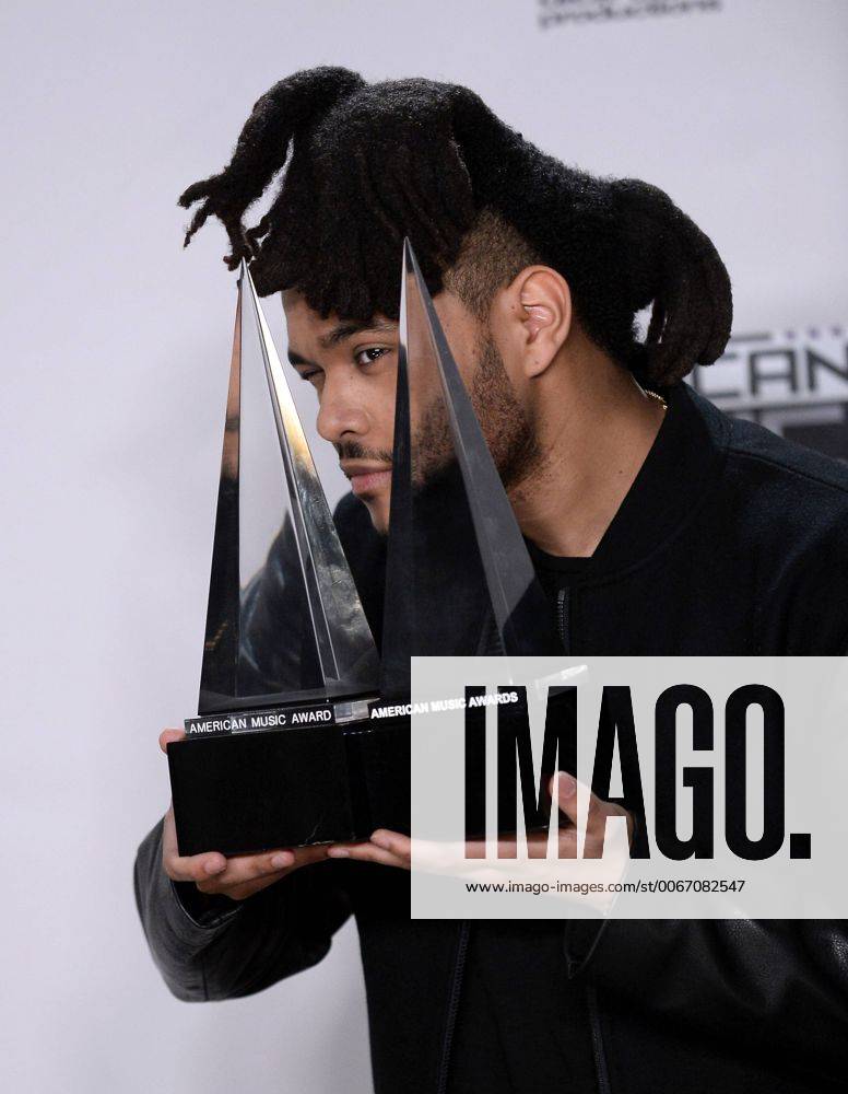 Recording artist The Weeknd, winner of Favorite Soul R&B Male Artist and Favorite Soul R&B Album, appears backstage during the 43rd annual American Music Awards held at Microsoft Theater in Los Angeles on November 22, 2015. LAP20151122428 JIMxRUYMEN