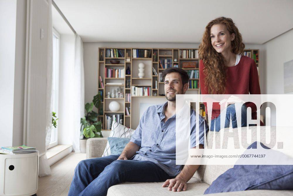 Relaxed couple at home on couch model released Symbolfoto property released RBF003526