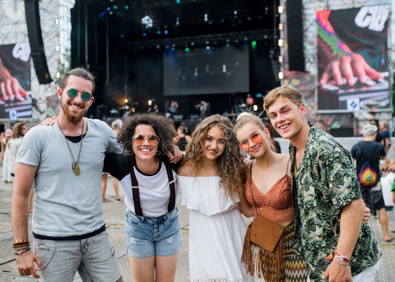 Group of young friends at summer festival., Group of cheerful young friends at summer festival, looking at camera.
