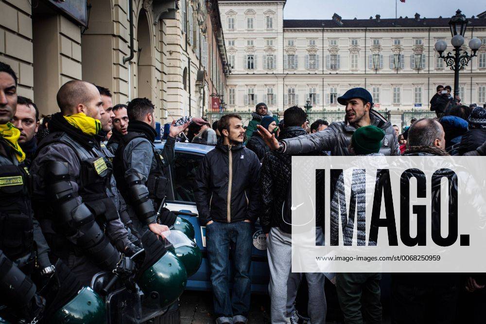 Dec. 9, 2013 - Turin, Italy - Italy in rebellion. People protest in Turin, on December 9, 2013..In photo: The agents of GCOM of the Guardia di Finanza take off their helmets as a sign of calm and begin to fraternize with the protesters...Photo: Cesare Quinto NurPhoto - ZUMAn23