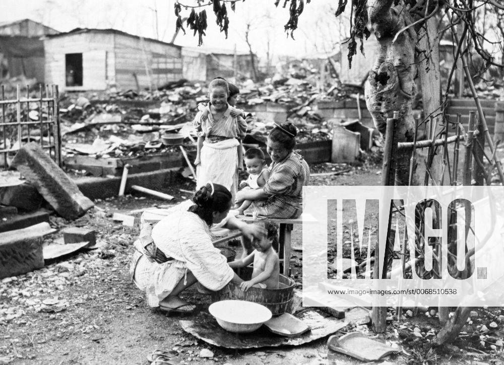 Yokohama, Japan: November 7, 1923 A baby getting his bath amongst the ruins left over from the Great Kanto Earthquake. in September. xUnderwoodxArchives 9-Japan-Women_1