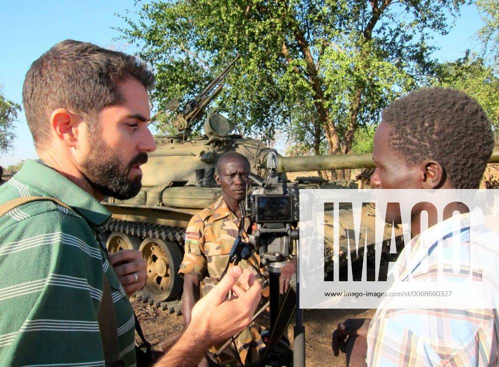Dec. 12, 2012 - SDN - Ryan Boyette, left, works with Yassin Hassen, right, in an interview with a rebel in Sudan s Nuba Mountains. Boyette started the Nuba Reports website in 2011 and recruited Hassen to join as a citizen journalist. - ZUMAm67_