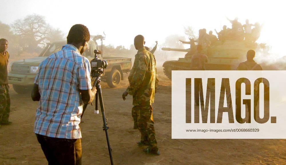 Dec. 12, 2012 - SDN - Yassin Hassen, a citizen journalist for the Nuba Reports website, shoots video at a rebel position in Sudan s Nuba Mountains. - ZUMAm67_