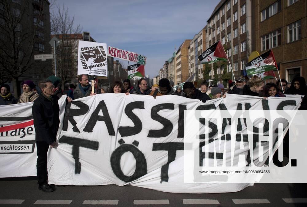 Gedenkmarsch Kolonialgeschichte DEU, Deutschland, Germany, Berlin, 27.02.2016 Demonstranten mit Transparent Rassismus toetet beim 10. Gedenkmarsch zur Erinnerung an die afrikanischen Opfer von Versklavung, Kolonialismus und rassistischer Gewalt vom Komitee fuer ein afrikanisches Denkmal in Berlin und afrikanischer Vereine in Berlin. Dieser Gedenkmarsch wurde ins Leben gerufen, um der Forderung nach Anerkennung der Verbrechen gegen Schwarze Menschen und Menschen afrikanischer Herkunft Nachdruck zu verleihen. Anlass ist die Berliner Afrika-Konferenz von 1884 - 1885, auf der Afrika vor 130 Jahren unter den europaeischen Kolonialmaechten aufgeteilt wurde. Mehr als 30 Millionen Afrikanerinnen und Afrikaner wurden Opfer von Versklavung und kolonialen Verbrechen gegen die Menschlichkeit. Die von Deutschland an den Herero und Nama begangenen Voelkermorde in Namibia und die Kriegsverbrechen in Ta