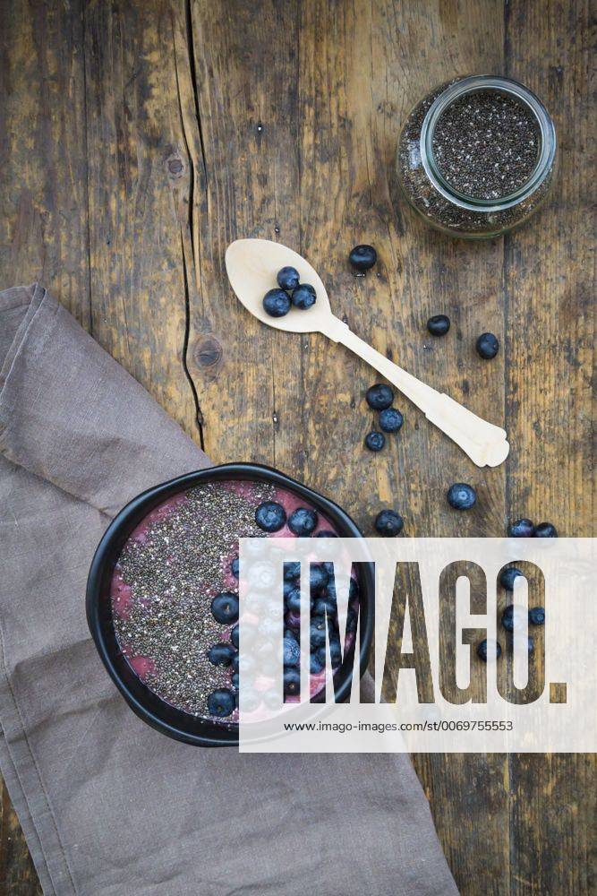 Blueberry smoothie with chia seeds in bowl, fresh blueberries LVF004502