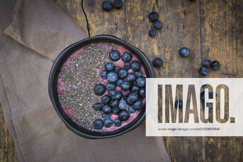 Blueberry smoothie with chia seeds in bowl, fresh blueberries LVF004501
